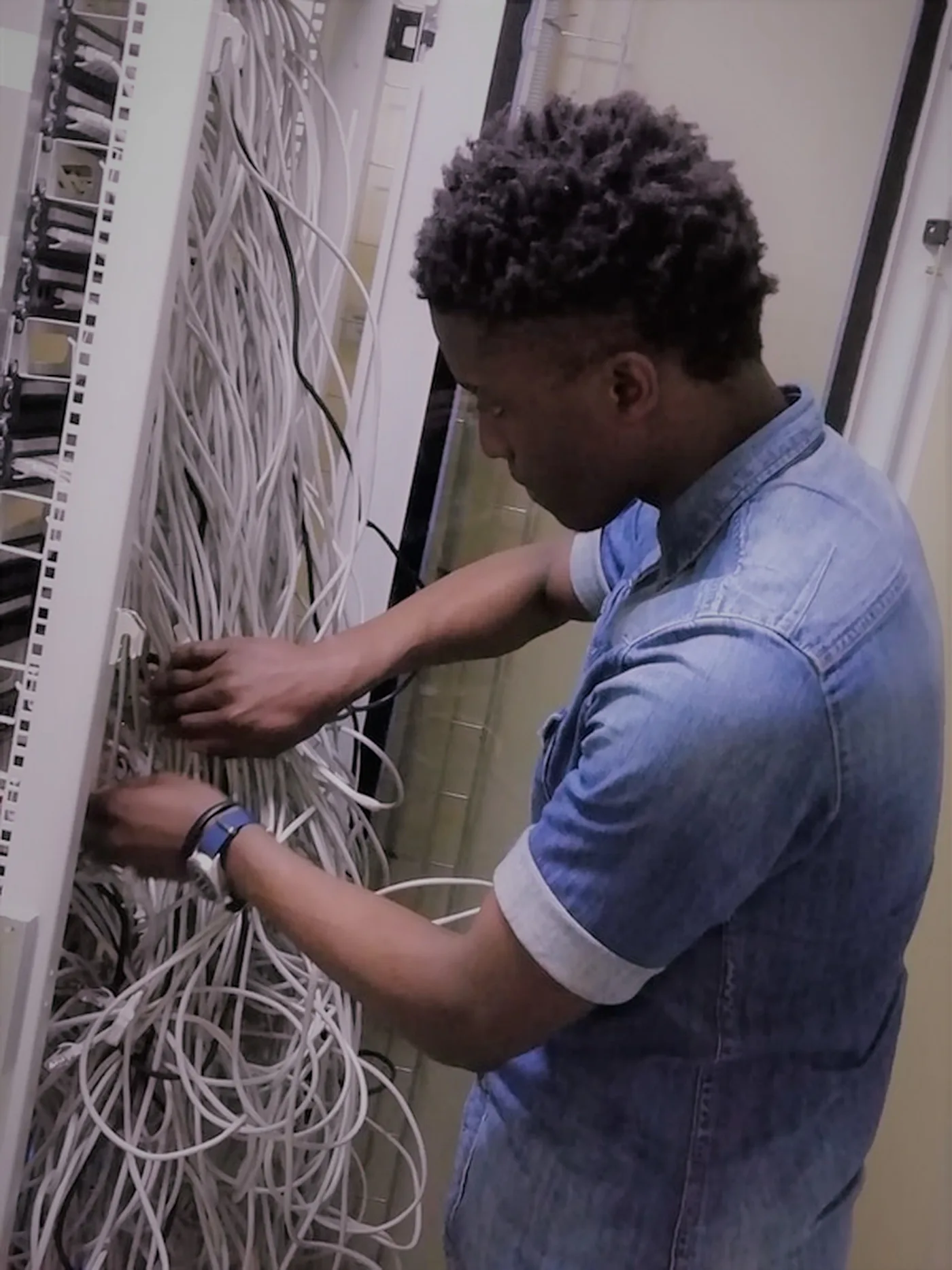 Engineer organising rack cabling
